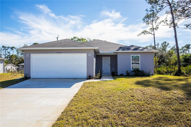 18059 Regan Ave, Port Charlotte, FL 33948 - view of front of property featuring a garage, driveway, and a front lawn