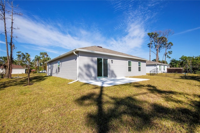 18059 Regan Ave, Port Charlotte, FL 33948 - rear view of house with a patio area and a yard