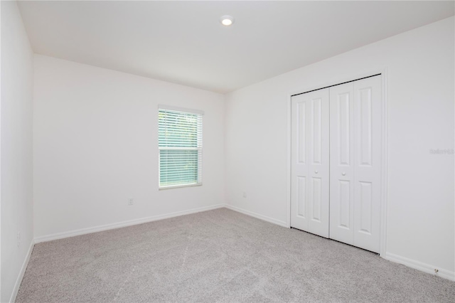18059 Regan Ave, Port Charlotte, FL 33948 - unfurnished bedroom with carpet, baseboards, and recessed lighting
