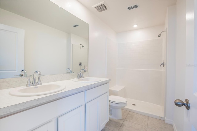 18059 Regan Ave, Port Charlotte, FL 33948 - bathroom featuring tile patterned floors, double vanity, toilet, and a tile shower