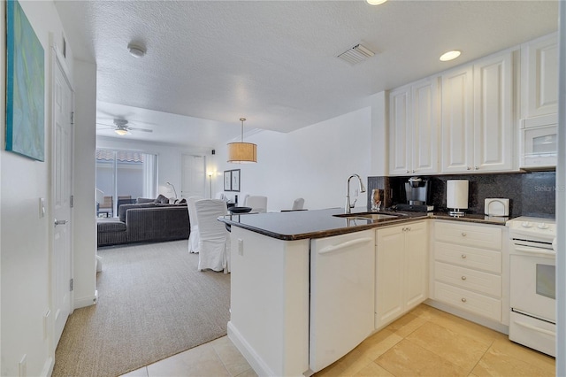 kitchen featuring white appliances, kitchen peninsula, sink, and ceiling fan