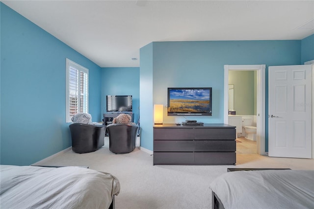 bedroom with light colored carpet and ensuite bathroom