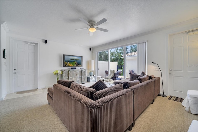 living room featuring light carpet, a textured ceiling, and ceiling fan