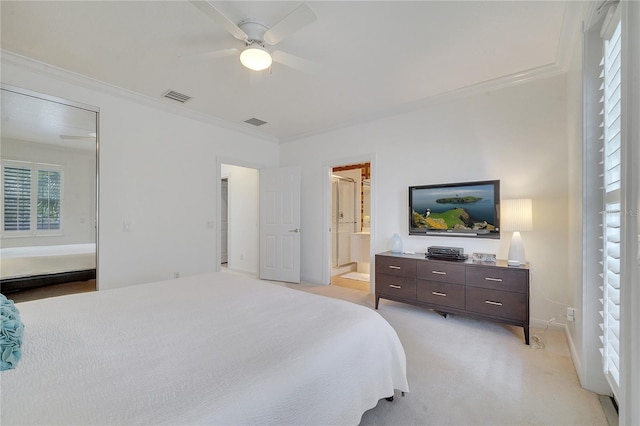 bedroom featuring ceiling fan, ensuite bath, and multiple windows