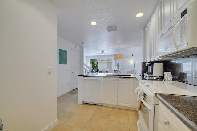 kitchen with white appliances, a textured ceiling, backsplash, sink, and ceiling fan