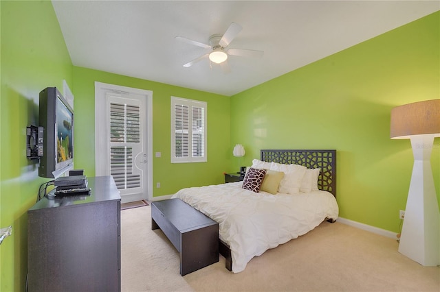 bedroom with light colored carpet, ceiling fan, and access to outside