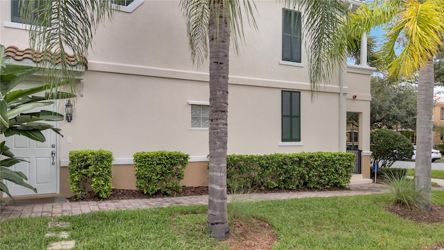 view of side of home featuring a lawn