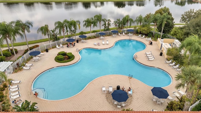 view of swimming pool with a water view and a patio