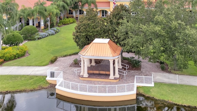 view of community with a water view, a yard, and a gazebo