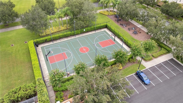 view of sport court with a lawn