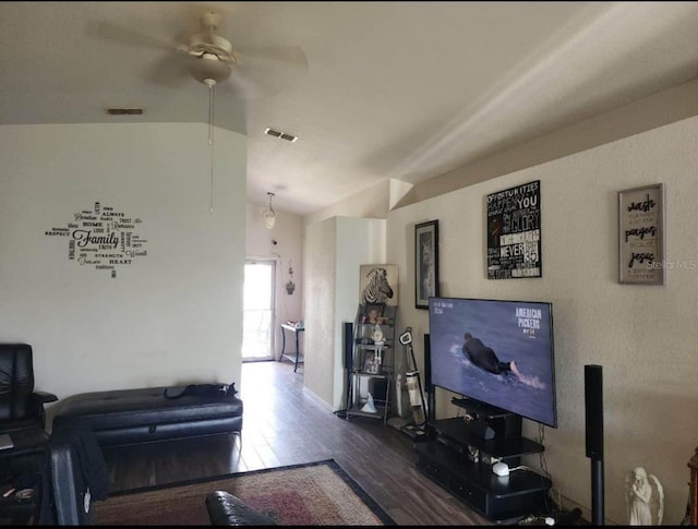 living room featuring lofted ceiling, ceiling fan, and dark wood-type flooring