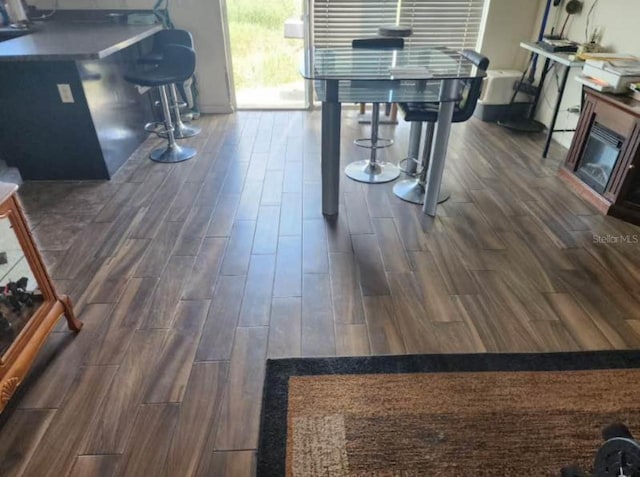 dining space with dark hardwood / wood-style flooring