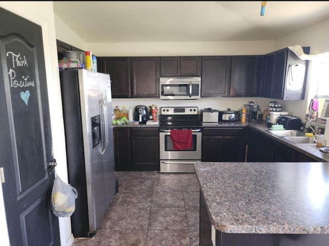 kitchen with dark brown cabinets, stainless steel appliances, and kitchen peninsula