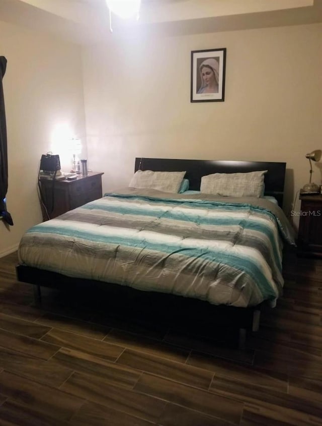 bedroom featuring dark hardwood / wood-style flooring