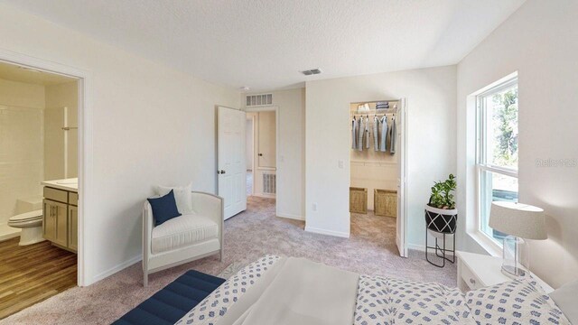 interior space with a textured ceiling and light colored carpet