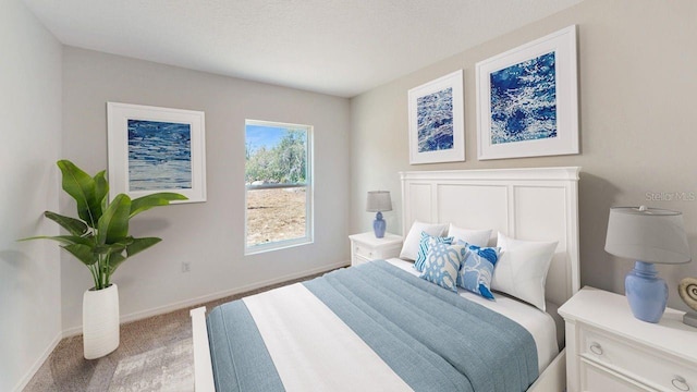 bedroom featuring light colored carpet and a textured ceiling