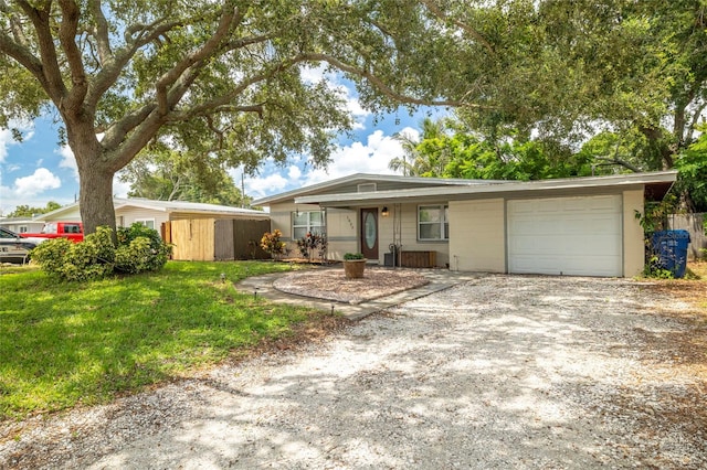 single story home with a garage and a front yard