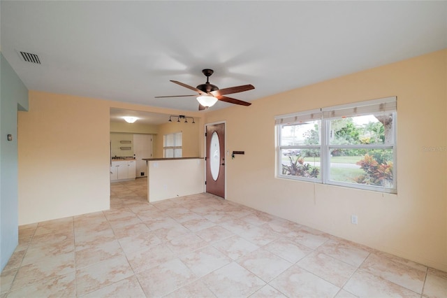 unfurnished room with ceiling fan