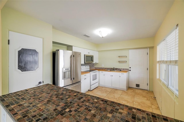 kitchen with white cabinets, appliances with stainless steel finishes, and sink