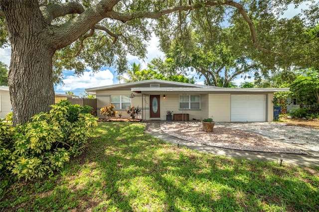 ranch-style house featuring a garage and a front yard