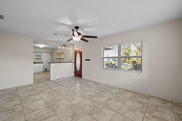 empty room with ceiling fan and visible vents