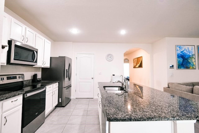 kitchen featuring white cabinetry, sink, stainless steel appliances, and a center island with sink