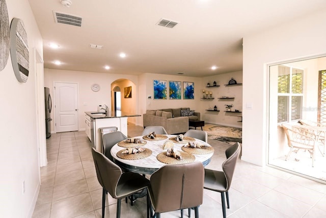 dining space with light tile patterned flooring and sink