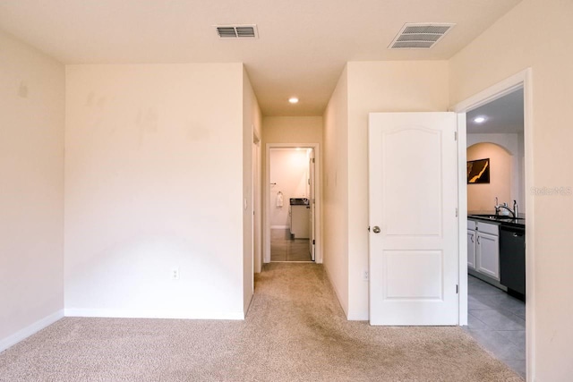 hall with light carpet and sink