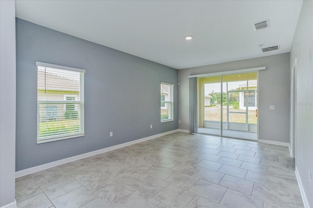 unfurnished room featuring light tile patterned flooring