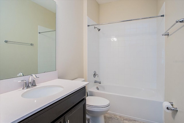 full bathroom with tile patterned floors, tiled shower / bath, vanity, and toilet