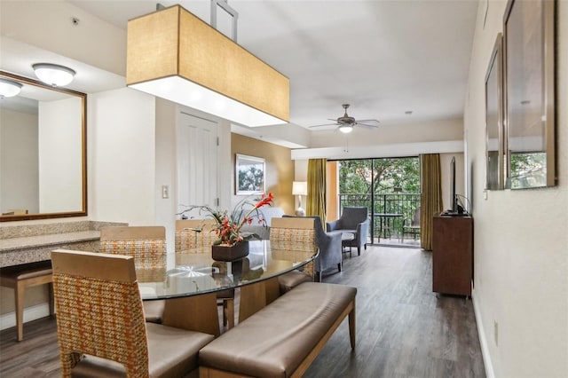 dining area with dark hardwood / wood-style flooring and ceiling fan