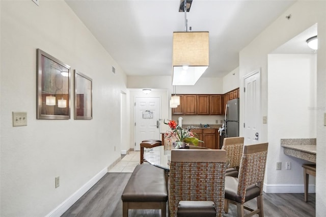 dining space featuring light hardwood / wood-style floors