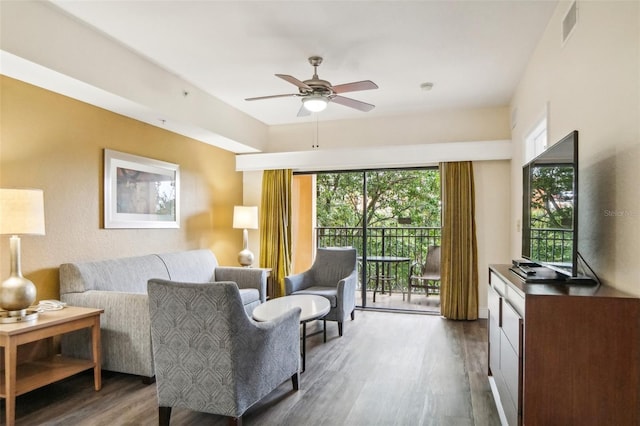 living room with ceiling fan and dark hardwood / wood-style floors