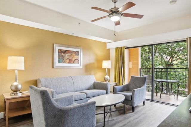 living room with ceiling fan and hardwood / wood-style floors