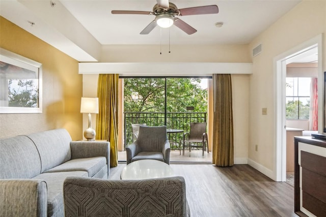 living room with ceiling fan and hardwood / wood-style floors