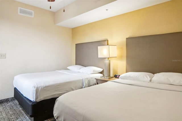 bedroom featuring dark carpet and ceiling fan