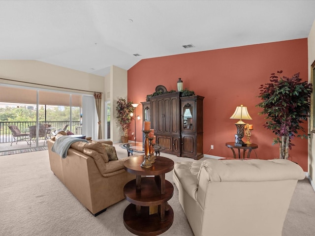 carpeted living room with vaulted ceiling