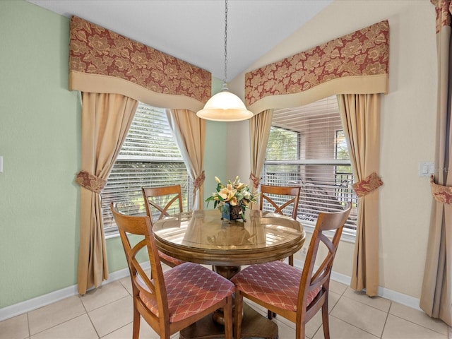 tiled dining area with vaulted ceiling and plenty of natural light