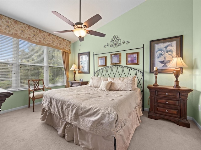 carpeted bedroom featuring ceiling fan and vaulted ceiling