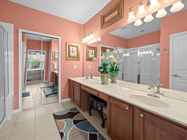 bathroom with dual bowl vanity, a shower with shower door, and tile patterned flooring