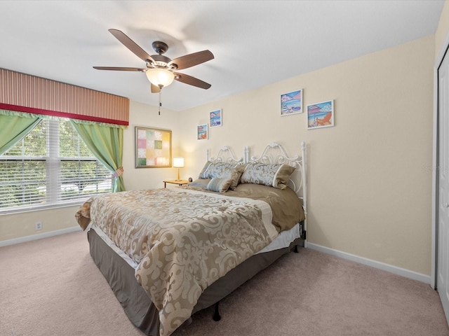 bedroom with ceiling fan and light carpet