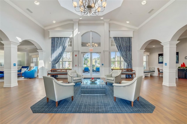 living room with a wealth of natural light, a chandelier, and hardwood / wood-style floors