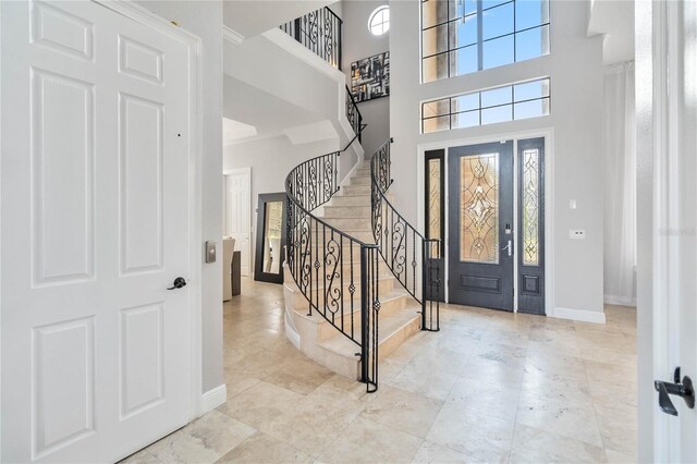 tiled foyer entrance with a high ceiling