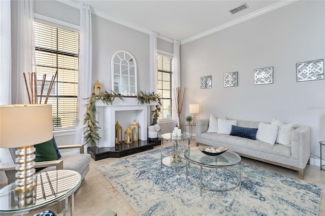 living room with ornamental molding and tile patterned flooring