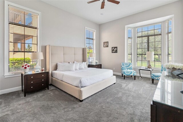 carpeted bedroom featuring ceiling fan and multiple windows