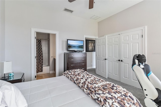 carpeted bedroom featuring connected bathroom, a closet, and ceiling fan