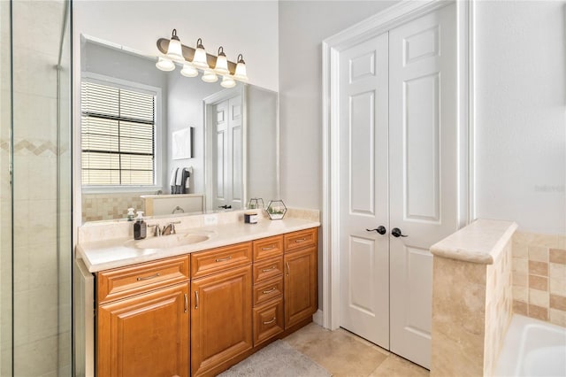 bathroom with vanity, a washtub, and tile patterned flooring