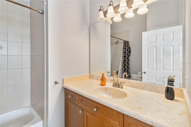 full bathroom with vanity, toilet, and tiled shower / bath