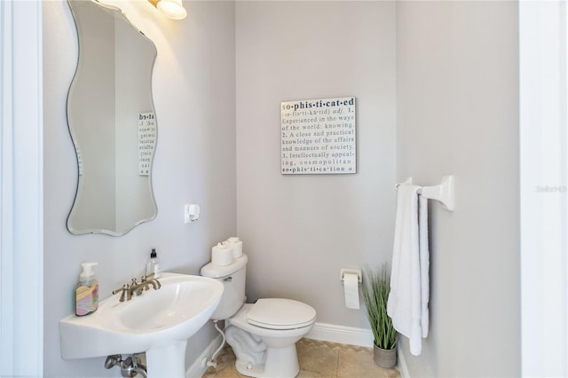 bathroom featuring toilet and tile patterned flooring