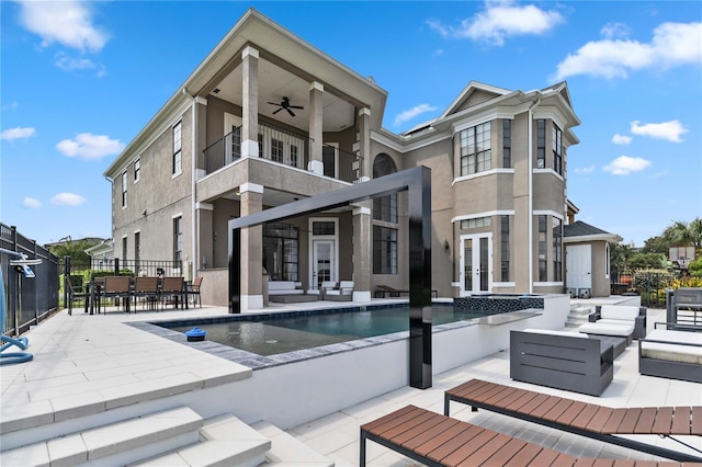 view of pool featuring a patio, ceiling fan, and an outdoor living space